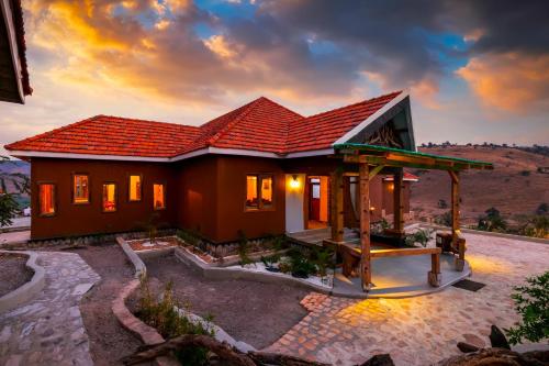 a small house with a red roof at Kigarama Wilderness Lodge Mburo in Bakijurura