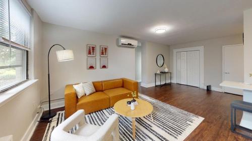 a living room with a couch and a table at Avenue B152 Perfect 2br! Pool Parking Gym in Philadelphia