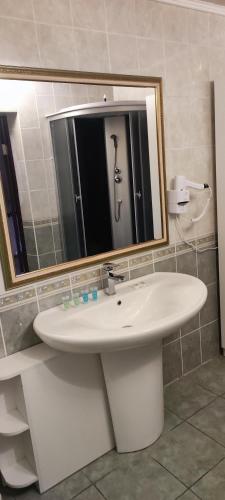a bathroom with a sink and a mirror at Diamond De Luxe in Kolomyya