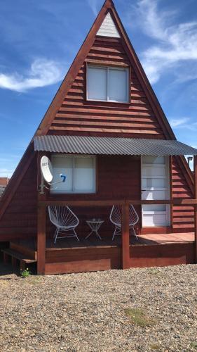 a house with a gambrel roof with two windows at Cabañas Hakuna Matata in San Blás