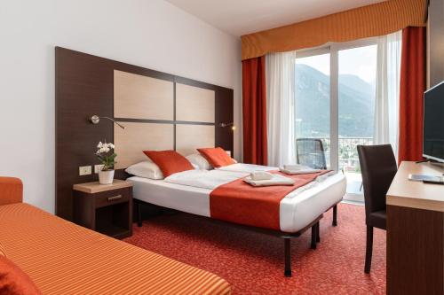Postel nebo postele na pokoji v ubytování Hotel Benacus Panoramic