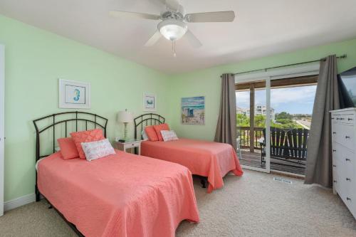 a bedroom with two beds and a balcony at SP8B Sea Pointe 8B in Nags Head