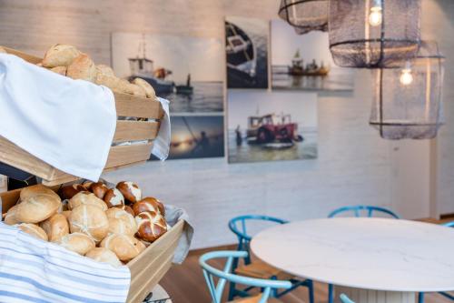 a basket of bread sitting next to a table at Motel One Rostock in Rostock