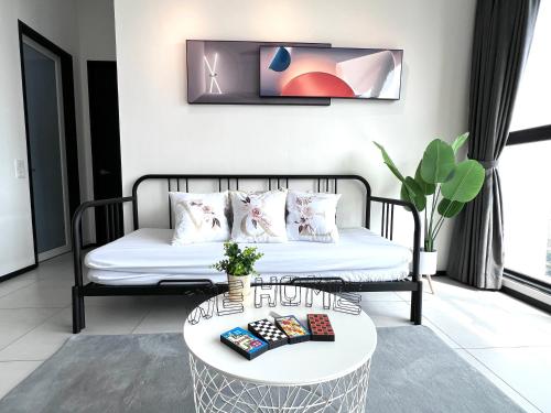 a living room with a couch and a table at Georgetown Skypool Urban 3BR Family & Baby-Friendly 9pax Seaview Penang in Jelutong