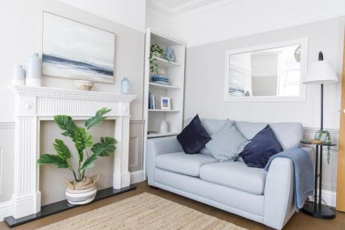 a living room with a couch and a fireplace at Grove Apartment with Free on street Parking in Worthing