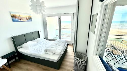Postel nebo postele na pokoji v ubytování Appart front de mer, 5e étage