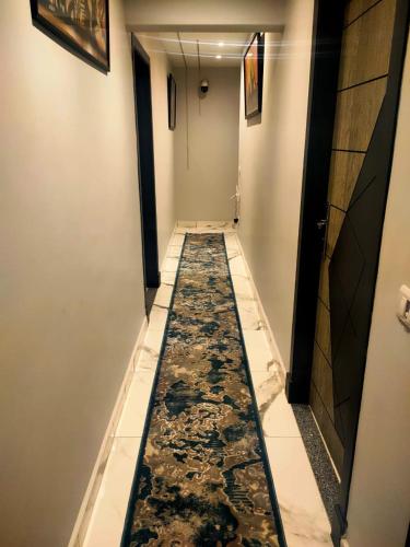 a long hallway with a marble floor in a building at WOW Pyramids Inn With Rooftop Lounge in Cairo