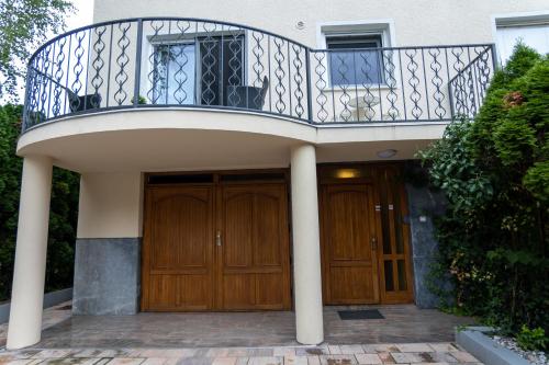 a balcony over the doors of a house at Emona Guesthouse Ljubljana in Ljubljana