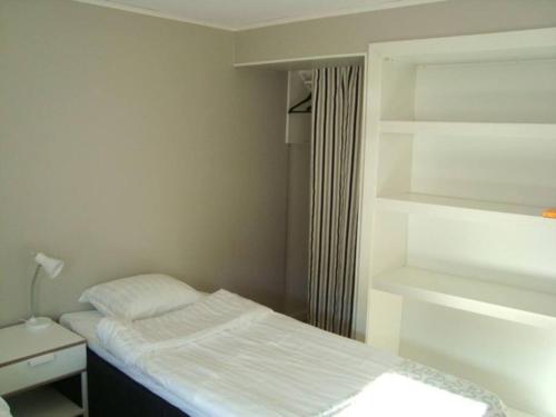 a small bedroom with a bed and a window at Modern 2 room apartment in the city centre in Luleå