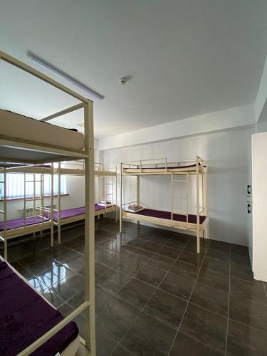 a room with three bunk beds in it at Aport hostel Alma-Ata in Almaty