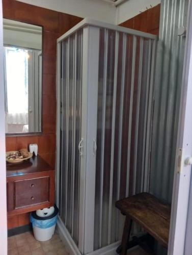 a bathroom with a shower stall and a wooden table at Sentieri in Levanto