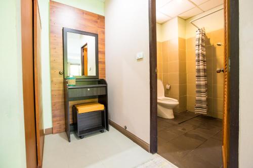 a bathroom with a sink and a toilet at Banlanna Hotel Lampang in Lampang