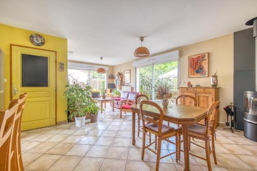 une salle à manger avec une table et des chaises dans l'établissement Maison calme et vue foret, à Andernos-les-Bains