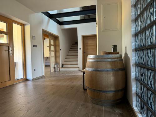 a large wooden barrel in a room with a staircase at Podhradí Landštejn in Slavonice