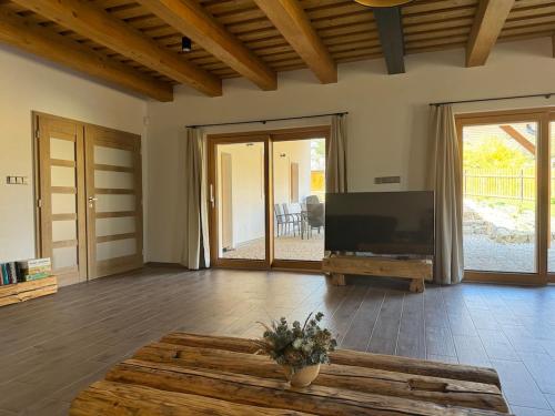 a living room with a flat screen tv and a table at Podhradí Landštejn in Slavonice