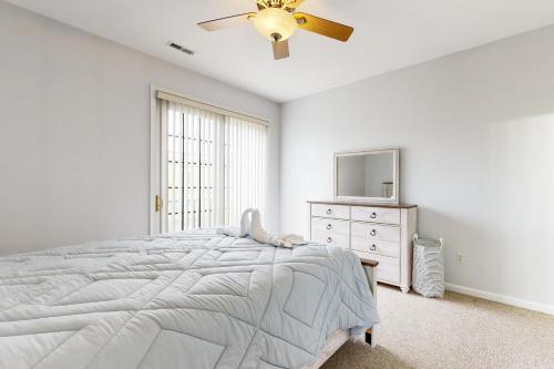 a white bedroom with a bed and a ceiling fan at Village of Five Points --- 33322 E Chesapeake St UNIT 46 in Lewes