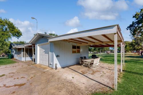 a white shed with a table in a yard at Belaire Boaters Bungalow in Granite Shoals
