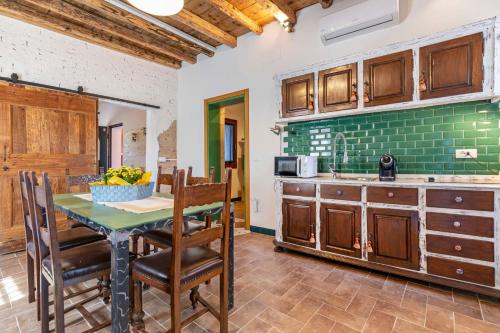 a kitchen with a table and chairs in a room at Cascina Ca' Storta - 15 minute to Venice in Martellago