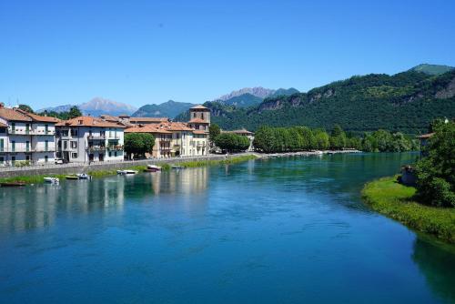 a river with houses and boats in a town at Il Pozzo - 1711 Luxury Guest House in Arlate