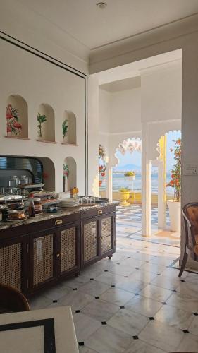 a large kitchen with a view of the ocean at Burj Baneria - A Boutique Homestay in Udaipur