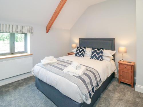 a bedroom with a large bed and a window at The Stables in Thirsk