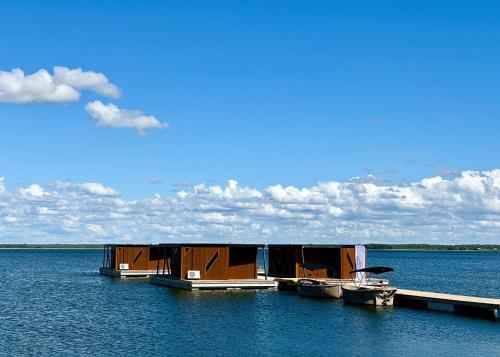 a house on a dock on a large body of water at Grand Holm Marina Ujuvmajad in Haapsalu