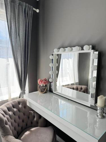 a mirror sitting on top of a glass table at Brother street apartment in Liepāja