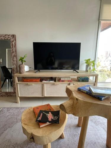 a living room with a tv and a coffee table at Lovely sunset department in Morón