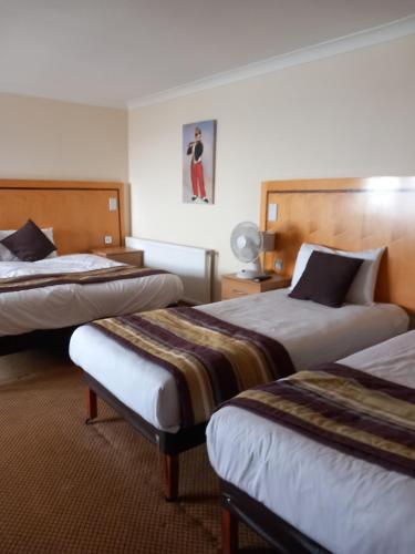 a hotel room with two beds in a room at Royal Hotel in Scarborough