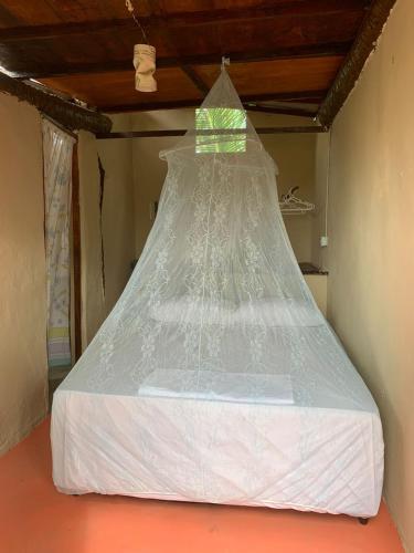 a bed covered in plastic in a room at Tatajuba Hostel Casa Pascual in Tatajuba