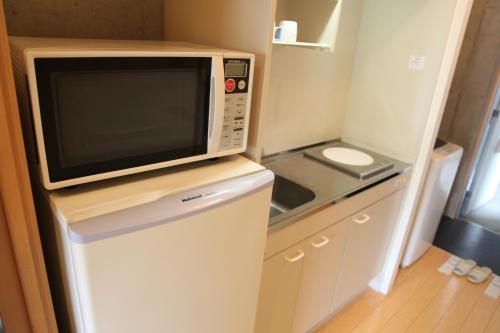 Kuchyň nebo kuchyňský kout v ubytování NAHA-WEST INN