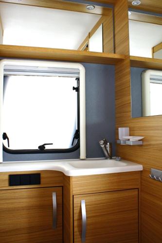 Mietwohnwagen في هورنوم: حمام مزود بحوض ومِرآة