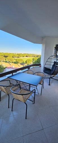a group of tables and chairs in a room at Golf & Mar - T2 Apartment in Vilamoura