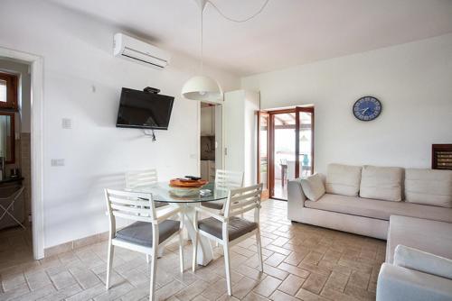 a living room with a table and a couch at Villa Mulino Al Vento in Lipari