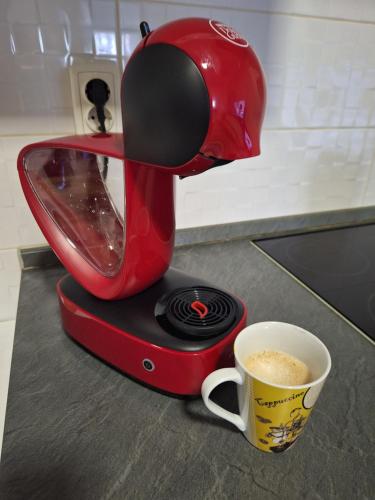 a red mixer sitting on a counter with a cup of coffee at Apartman Agata,Osijek, self check-in in Osijek