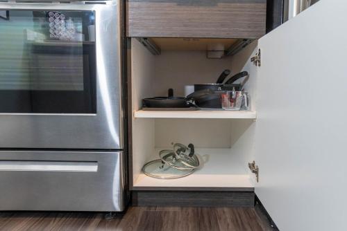 a kitchen with a refrigerator and some pots and pans at Self Check-in-washer-dryer-4ksmart Tv-king Bed-gym in Tacoma