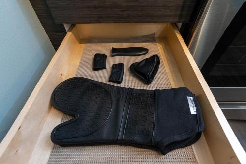 a box with a pair of shoes and a belt at Self Check-in-washer-dryer-4ksmart Tv-king Bed-gym in Tacoma