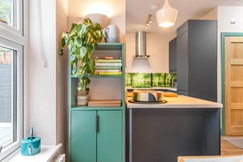 a kitchen with a blue shelving unit at Eco Friendly Luxury Townhouse with Parking in Norwich