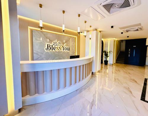 a lobby with a sign that reads bless you at Bless You in Piraziz