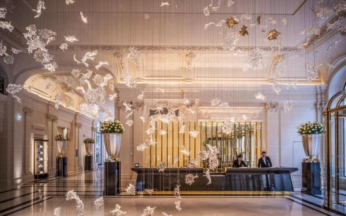 a lobby with a large organ in a building at The Peninsula Paris in Paris