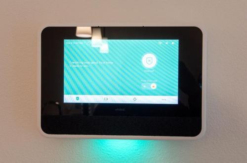 a tablet is hanging on a wall at Self Check-in-washer-dryer-4ksmart Tv-king Bed-gym in Tacoma