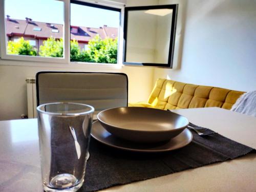 a table with a bowl and a glass on it at Palmeral Suite in Grado