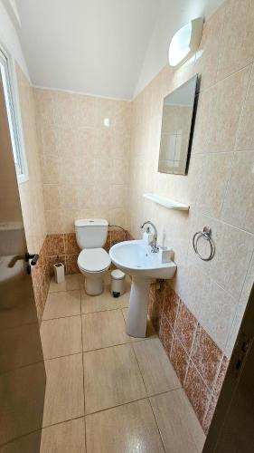 a bathroom with a toilet and a sink at Seaview Sanctuary House in Larnaka