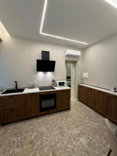 a kitchen with a sink and a microwave at Tosini's Home in Sale Marasino