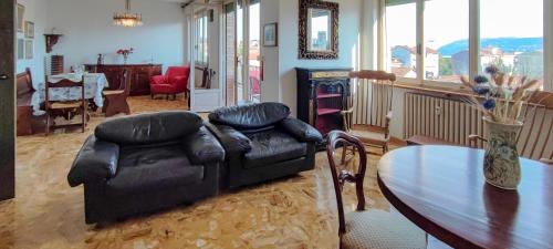 a living room with a couch and a table at RIVIERA, Large Four-Room Apartment with Balcony and Partial Lake View in Pallanza