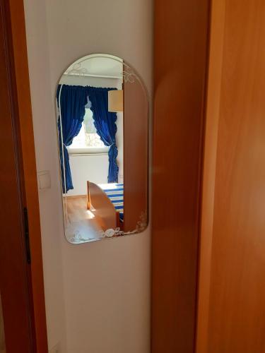 a mirror on a wall next to a room at Solis in Sveti Vid-Miholjice