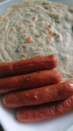 a pile of hot dogs on a plate with dip at CANAAN MUSIC Hotel in Moratuwa