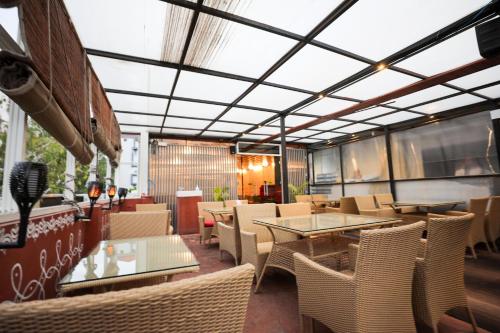 a dining room with tables and chairs at Hotel White Fields Hitec City, Hyderabad in Hyderabad