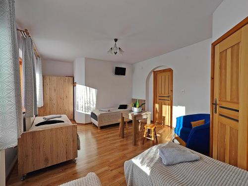 a room with two beds and a table in it at Kwatery Maciata in Biały Dunajec