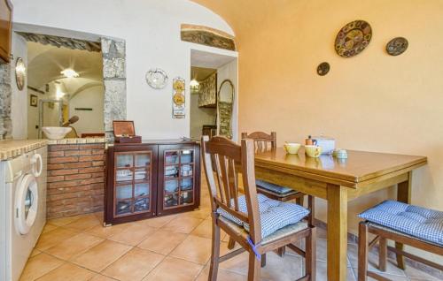 a kitchen with a wooden table and a laundry room at Stunning Apartment In Varese Ligure in Varese Ligure